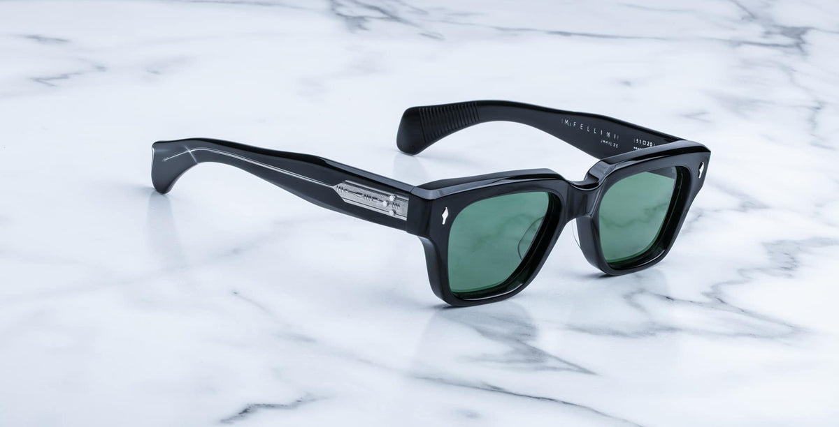 Jacques Marie Mage Fellini black rectangular sunglasses with green lenses, top view.
