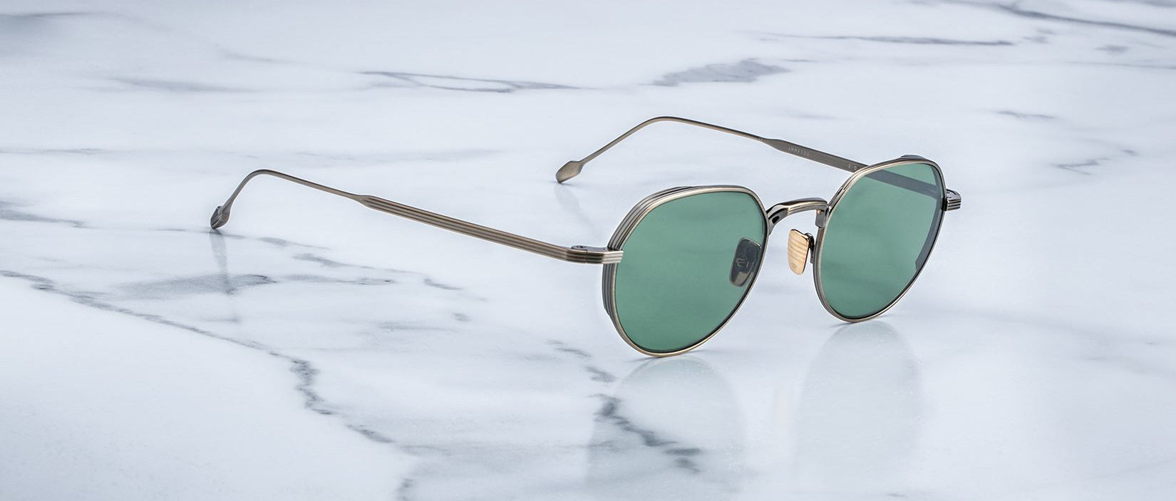 Angled view of the Jacques Marie Mage Fontana style sunglasses in colorway Gold Antique