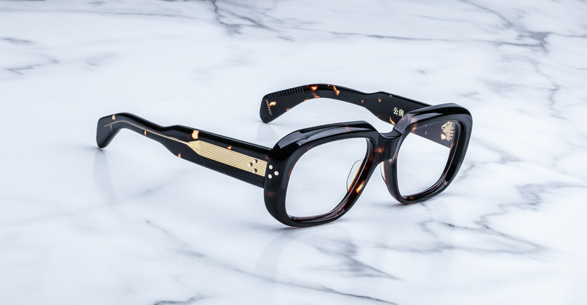 Jacques Marie Mage Kobo eyeglasses, thick tortoiseshell frame with gold accents, blue light lenses, shown from above.
