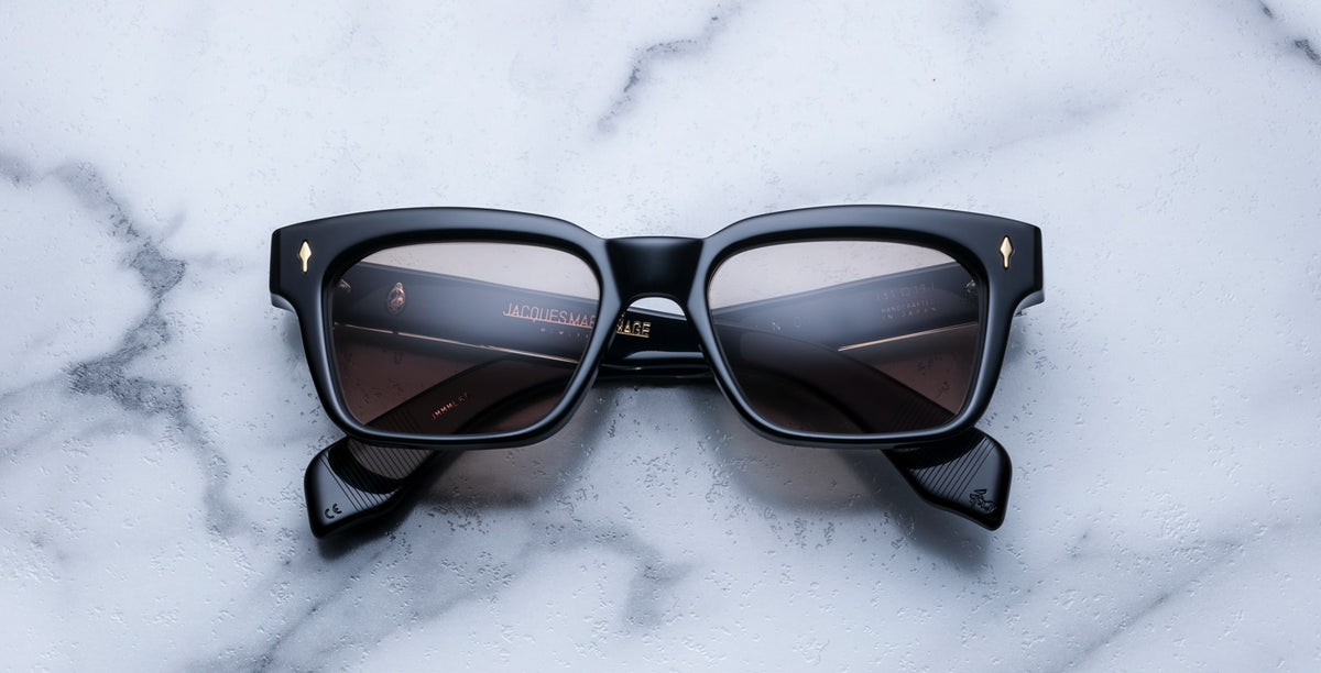 Jacques Marie Mage Molino black rectangular sunglasses with lenses, front view.