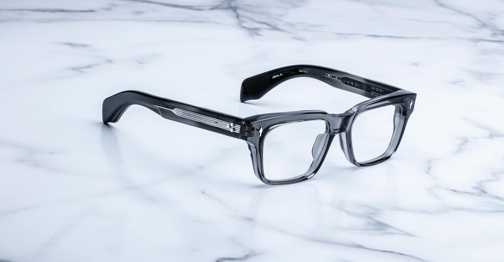 Jacques Marie Mage Molino eyeglasses, rectangular, thick clear acetate rims, shown from front angle.