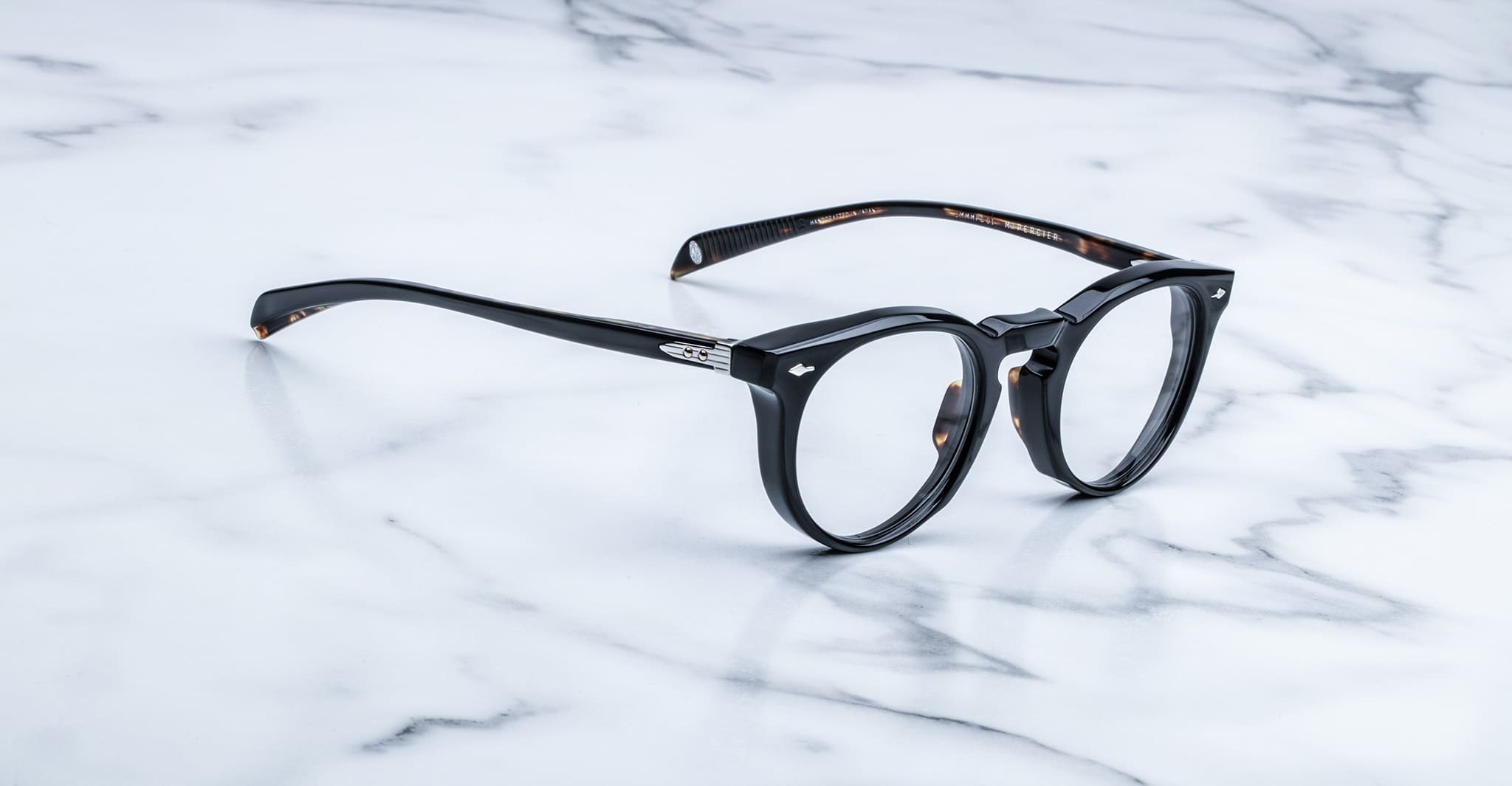 Jacques Marie Mage Percier black round eyeglasses with thick frames, front angle.