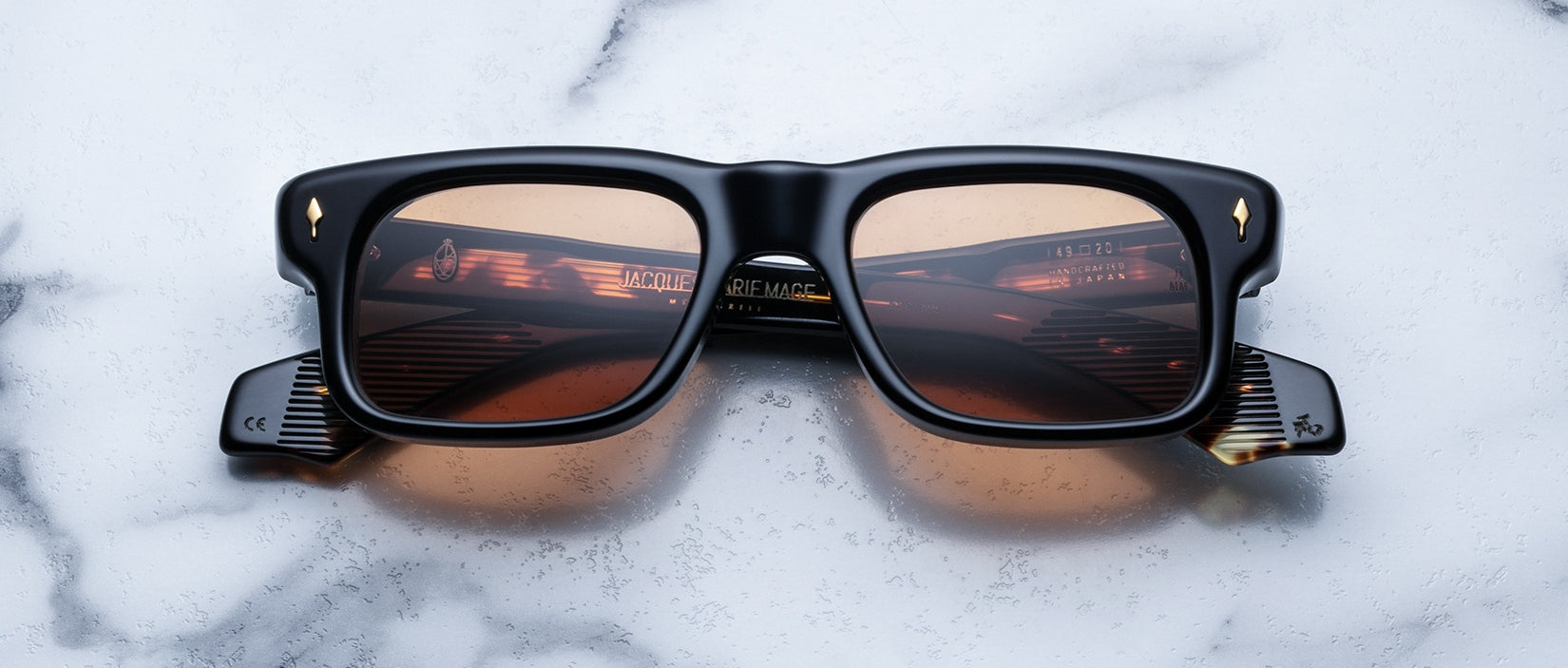 Jacques Marie Mage Saint black rectangular sunglasses with brown lenses, front view.