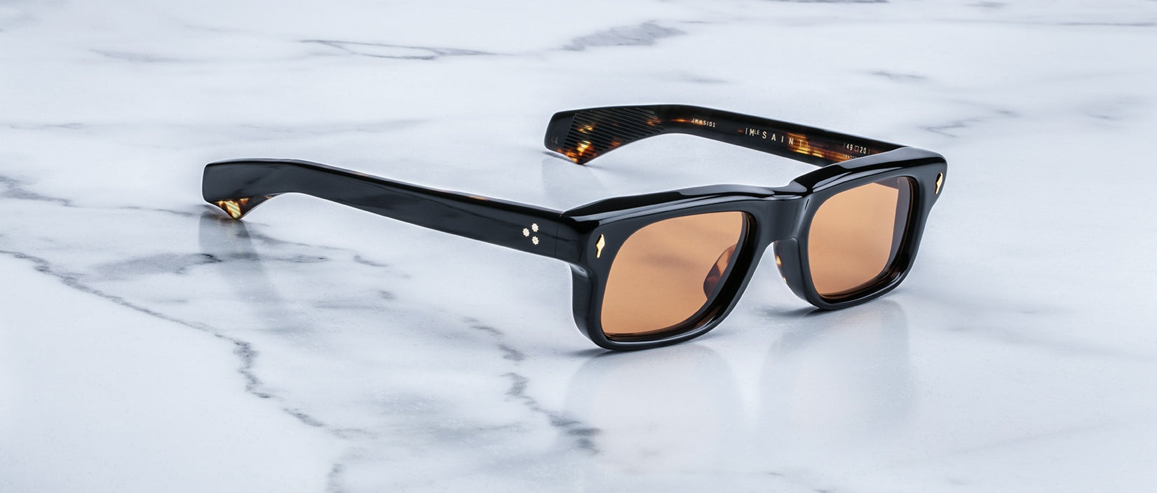 Jacques Marie Mage Saint sunglasses with black rectangular frames and brown lenses, viewed from the front.