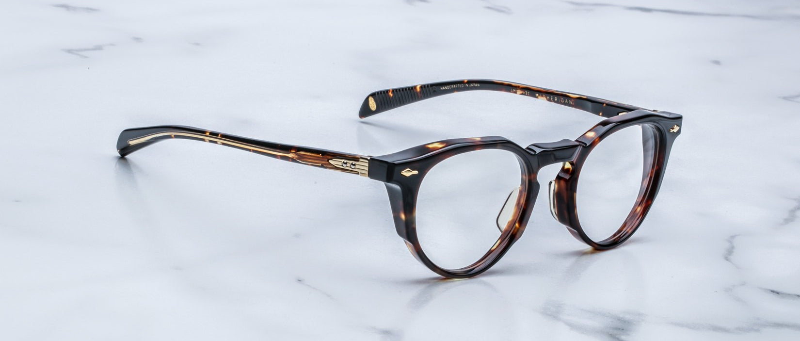Jacques Marie Mage Sheridan in Dark Havana, rich tortoiseshell acetate glasses with sculpted brow and gold hardware, angled view