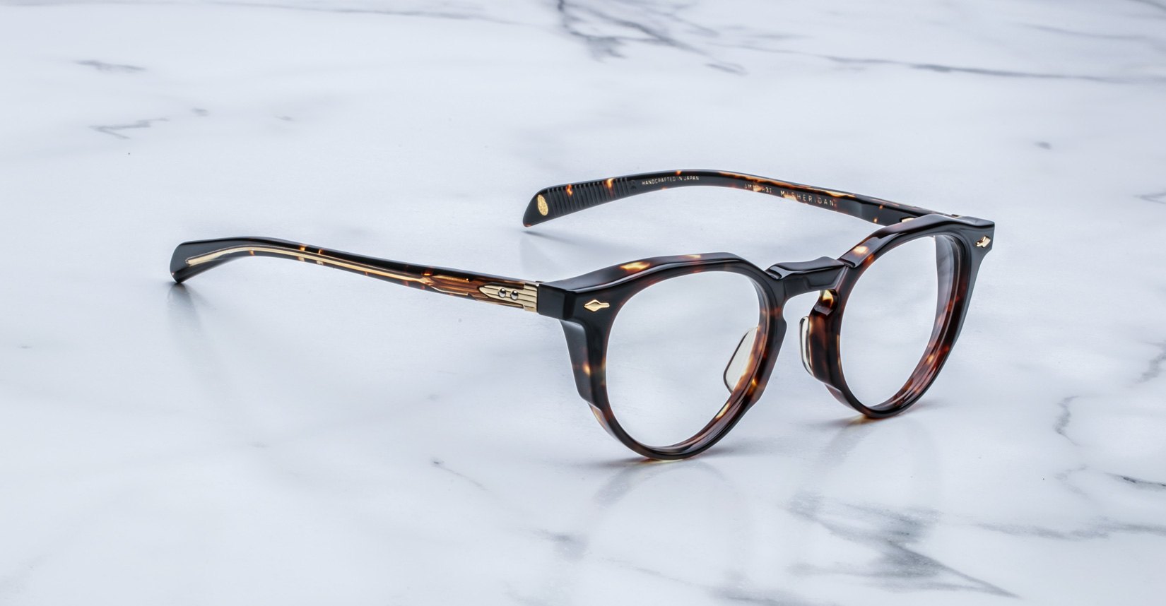 Jacques Marie Mage Sheridan in Dark Havana, rich tortoiseshell acetate glasses with sculpted brow and gold hardware, angled view
