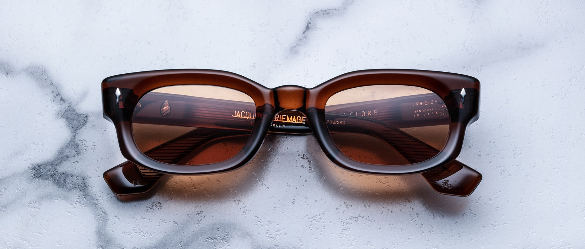 Jacques Marie Mage Whiskeyclone rectangular acetate sunglasses with thick frames, top view.