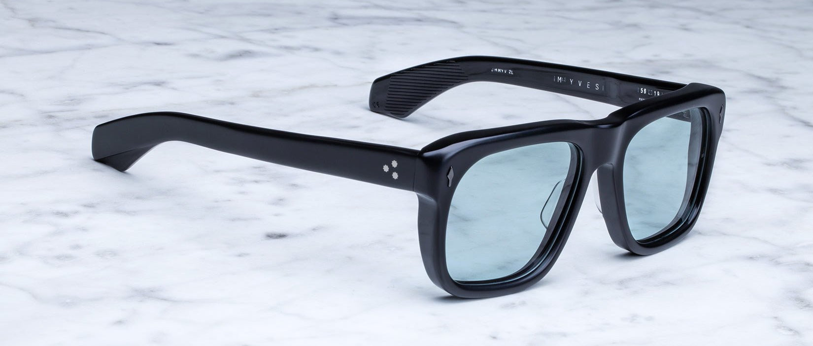 Jacques Marie Mage Yves black rectangular sunglasses with blue lenses, top view showing frames and tinted lenses.