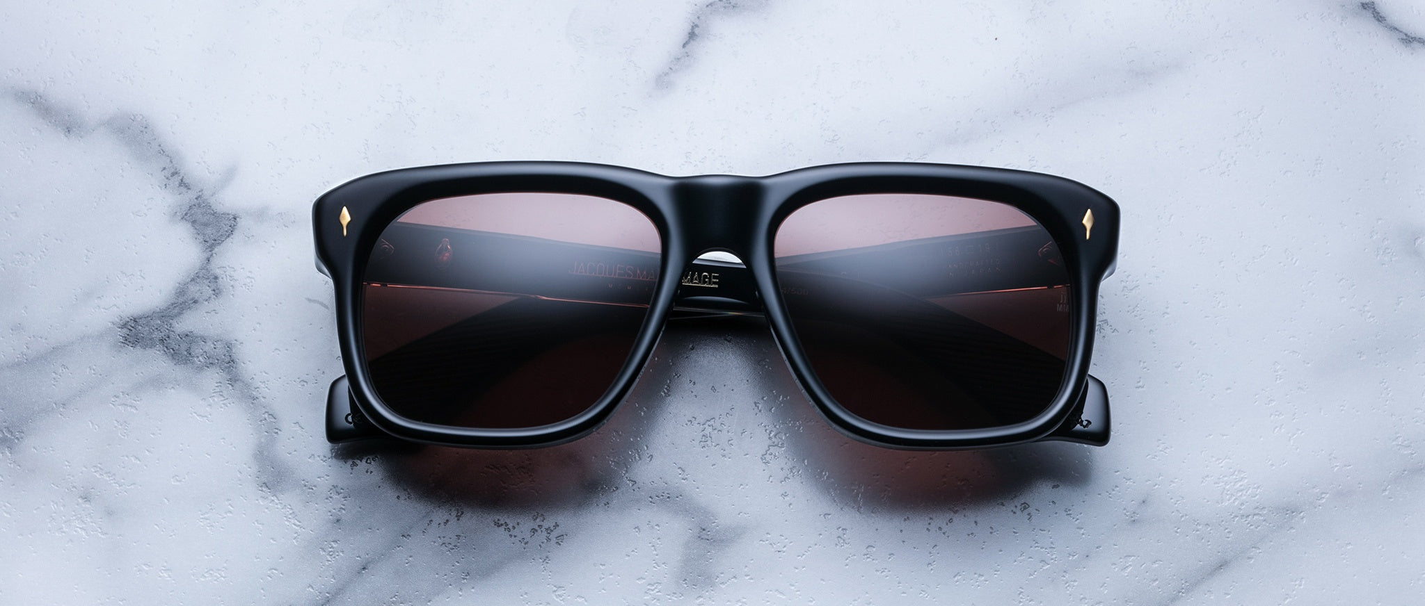 Jacques Marie Mage Yves black rectangular sunglasses with dark lenses, front view.