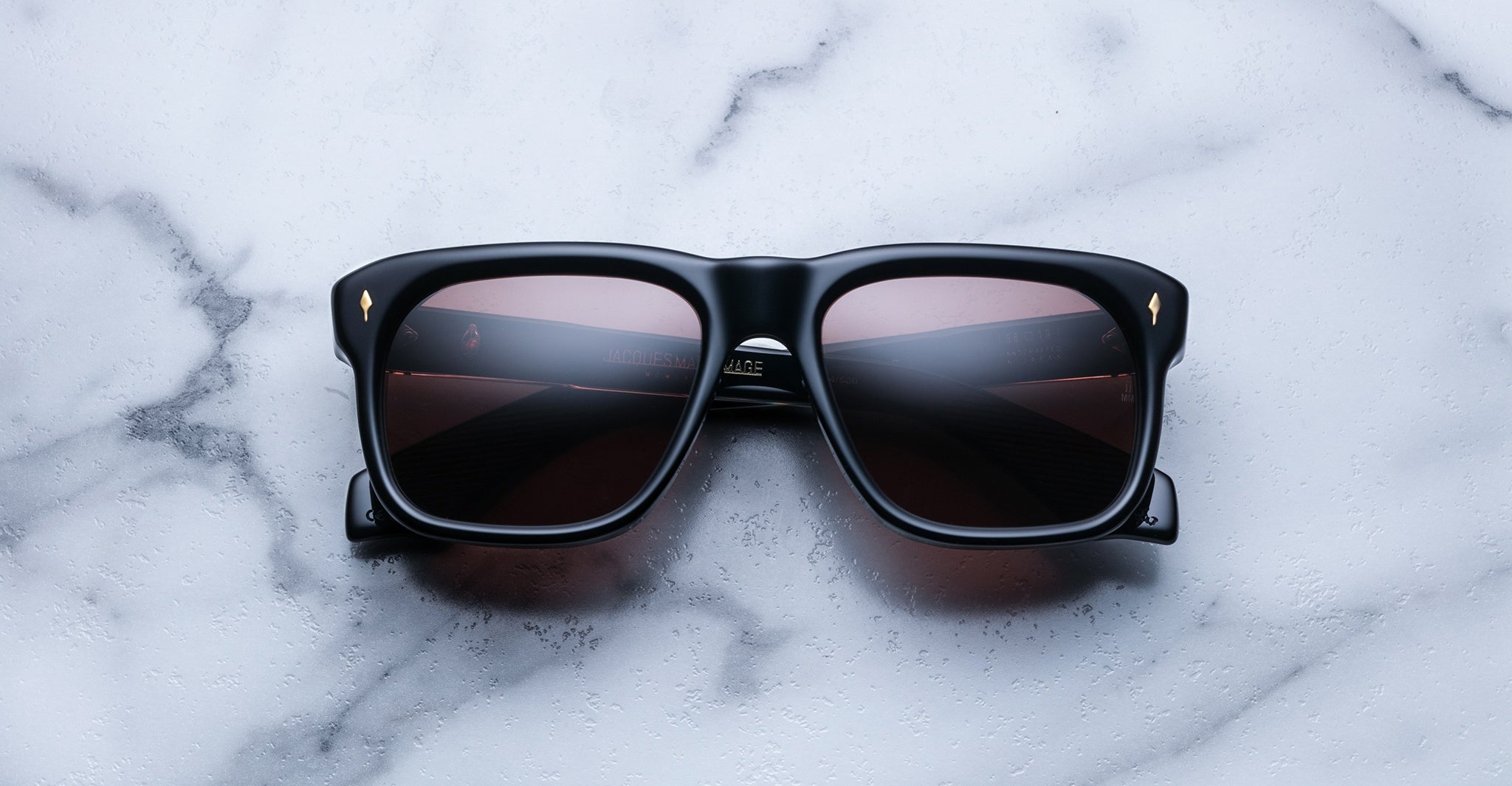 Jacques Marie Mage Yves black rectangular sunglasses with dark lenses, front view.
