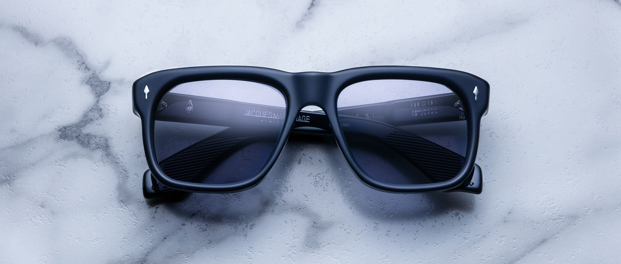 Jacques Marie Mage Yves black square-framed sunglasses with dark lenses, top view.