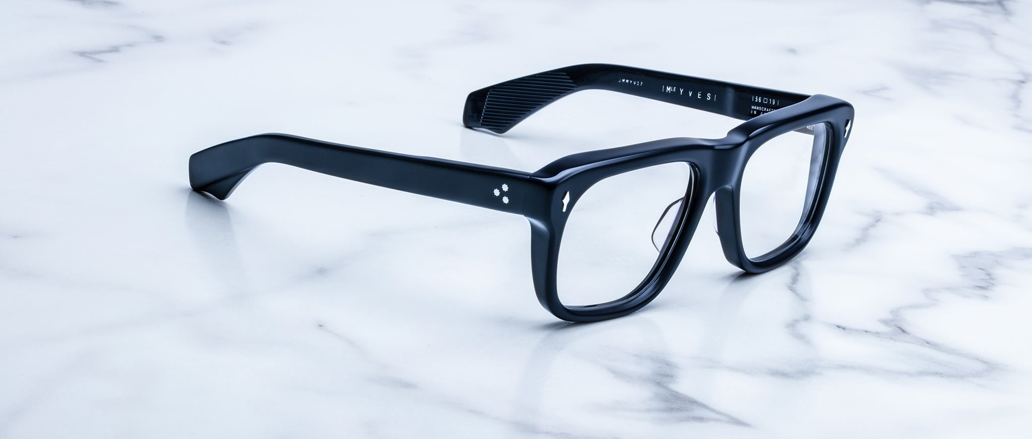Jacques Marie Mage Yves black rectangular eyeglasses with clear lenses, front view.