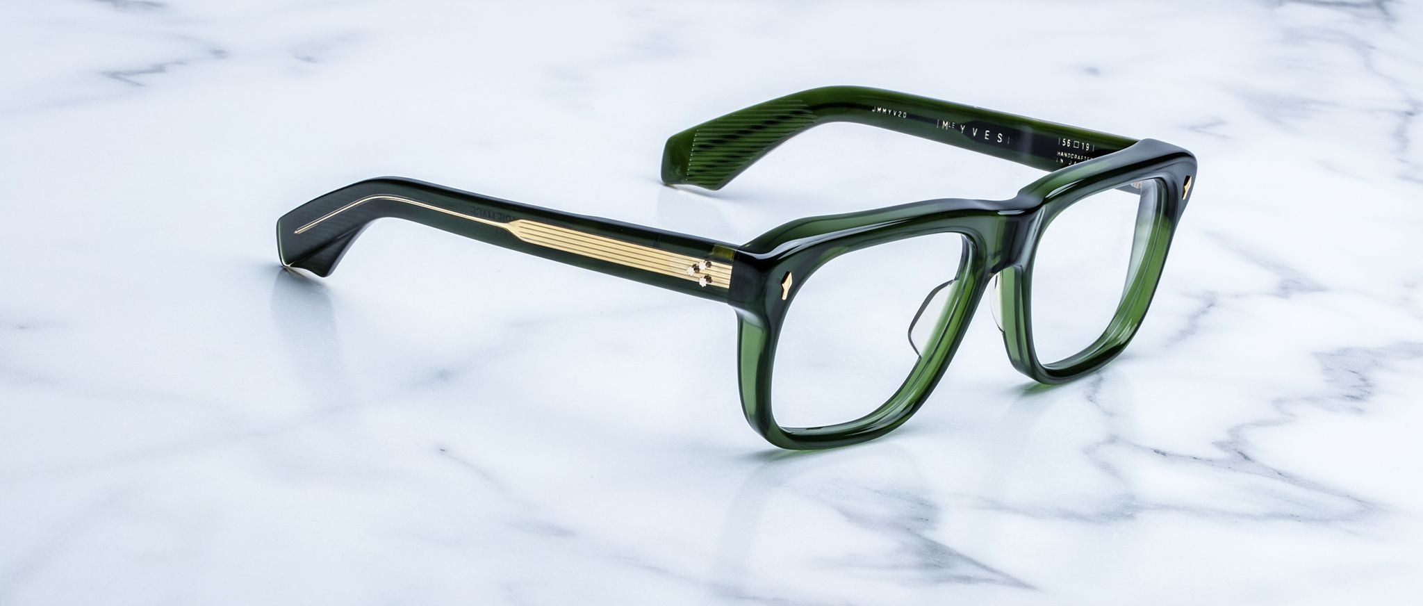 Jacques Marie Mage Yves green rectangular eyeglasses with gold accents, front angle view.