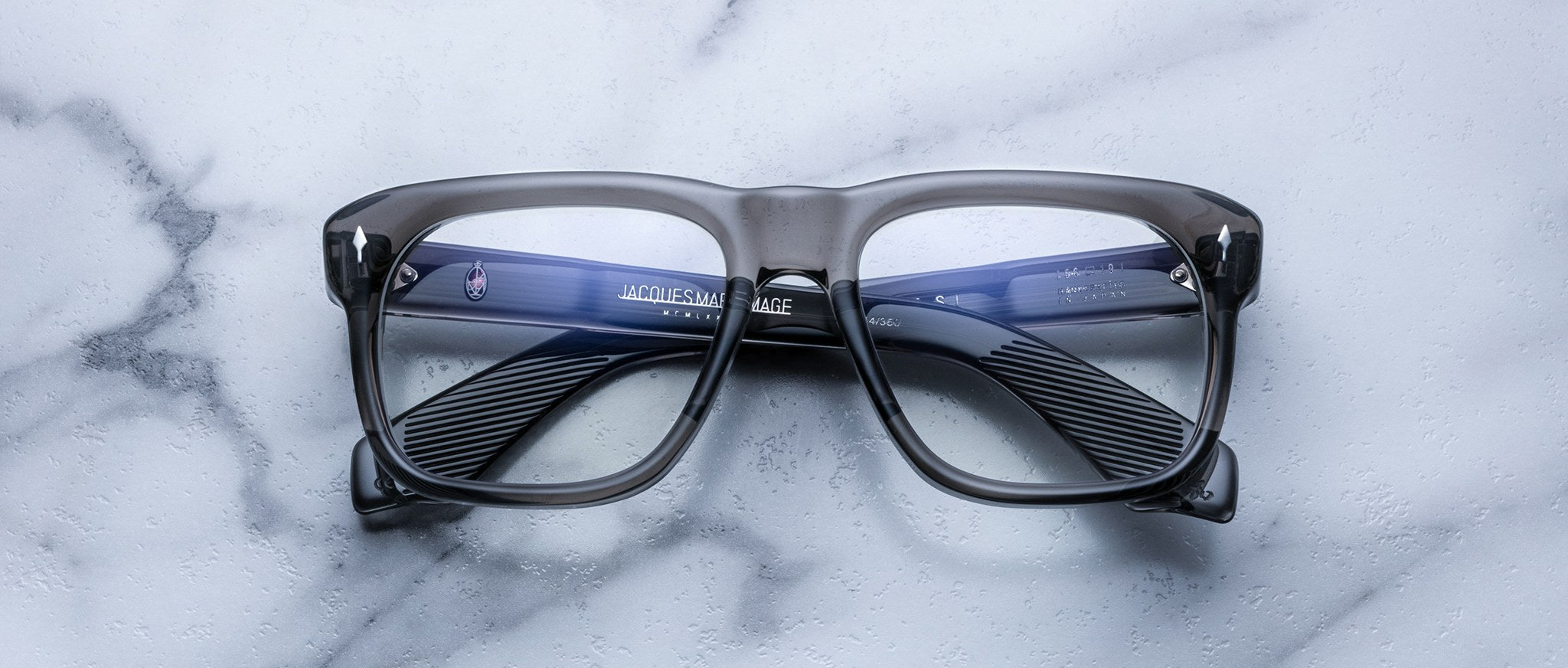 Jacques Marie Mage Yves rectangular eyeglasses with dark frames, top view.