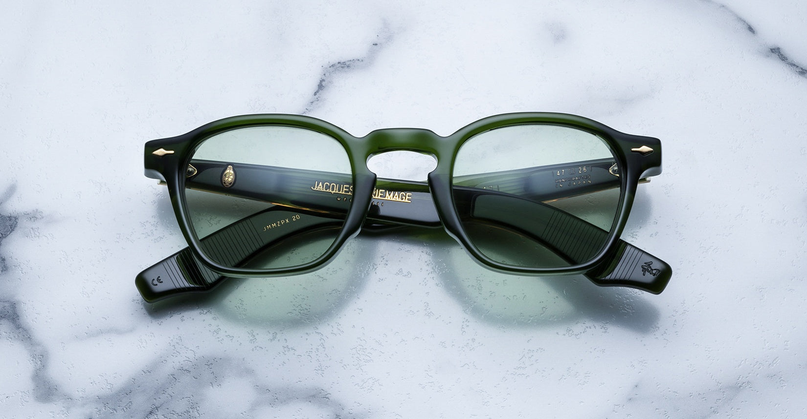 Jacques Marie Mage Zephirin 47 green-framed eyeglasses with clear lenses, viewed from above.