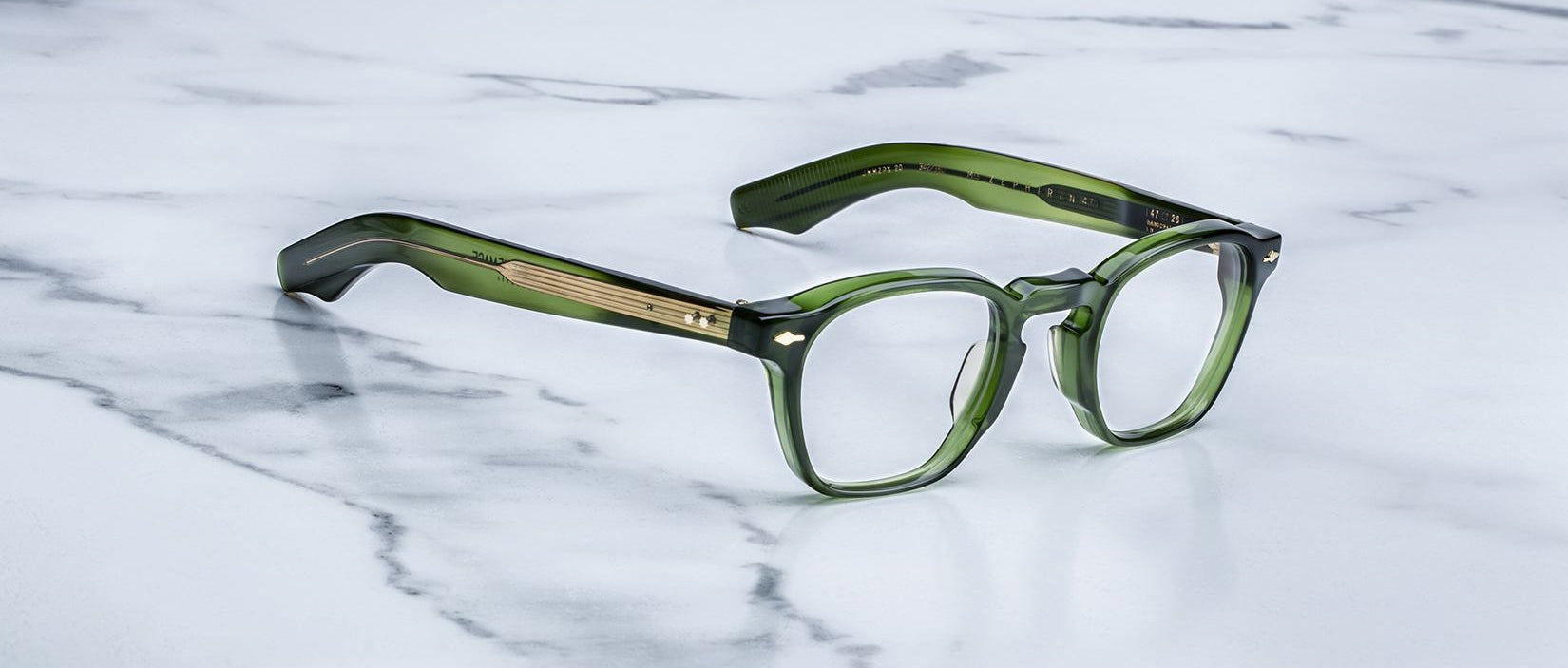Jacques Marie Mage Zephirin 47 rectangular eyeglasses with thick green frames and gold accents, front view.