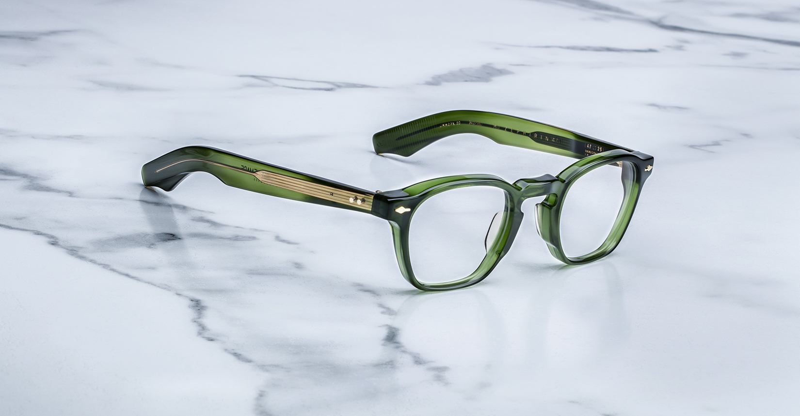 Jacques Marie Mage Zephirin 47 rectangular eyeglasses with thick green frames and gold accents, front view.