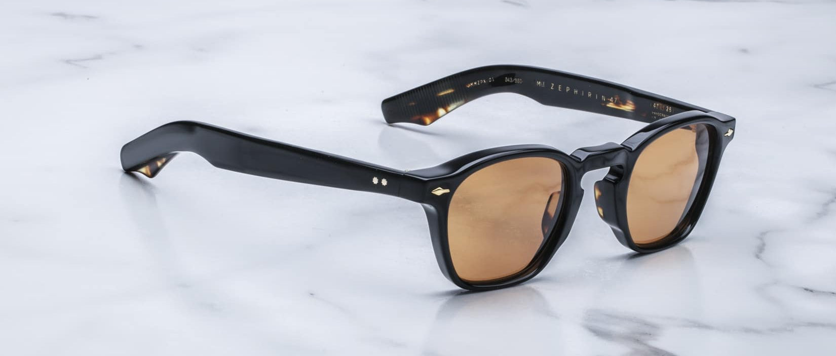 Jacques Marie Mage Zephirin 47 black-framed sunglasses with brown lenses, top view.