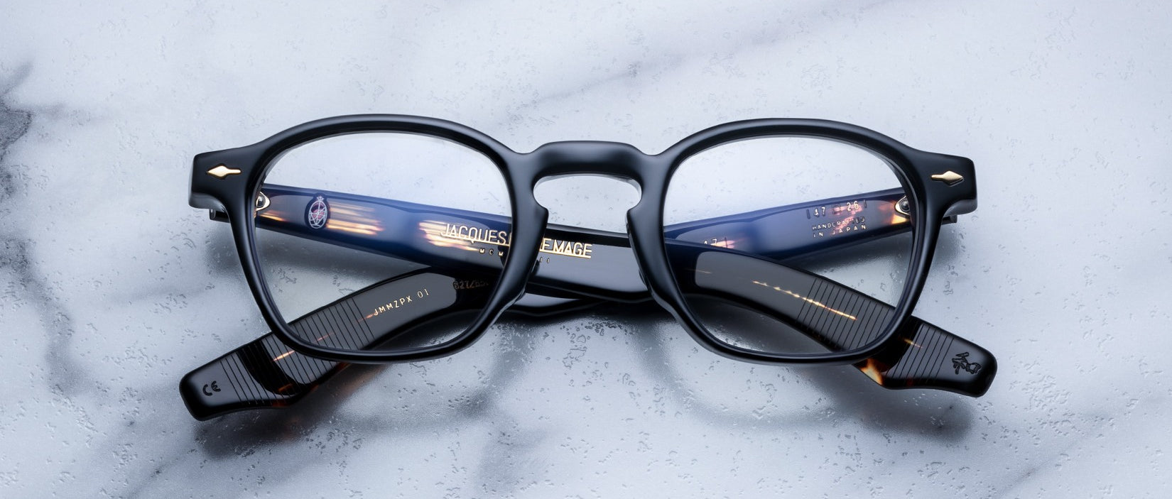 Jacques Marie Mage Zephirin 47 black eyeglasses with gold accents, top view.