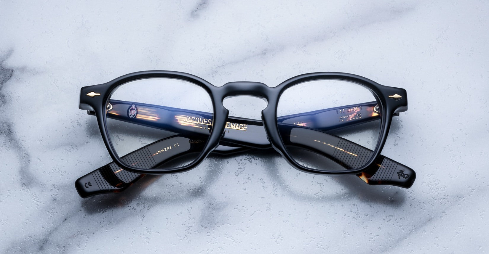 Jacques Marie Mage Zephirin 47 black eyeglasses with gold accents, top view.