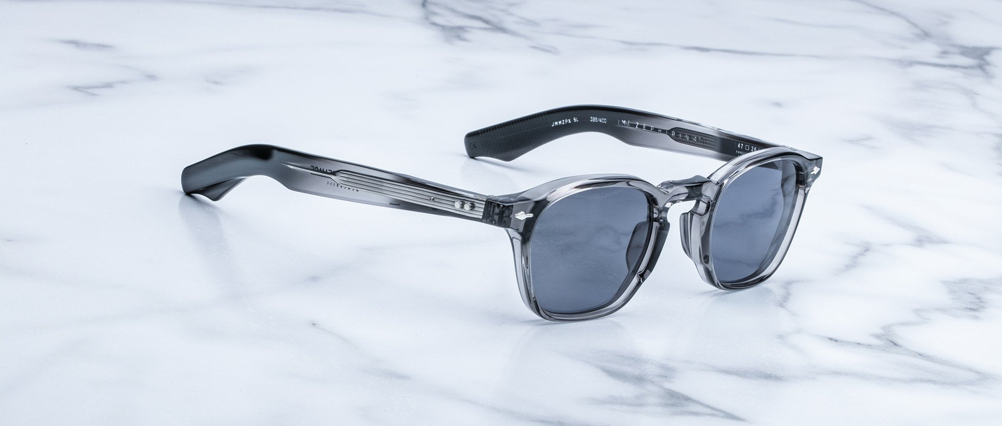 Jacques Marie Mage Zephirin 47 sunglasses, gray and black frames with dark lenses, shown from above.