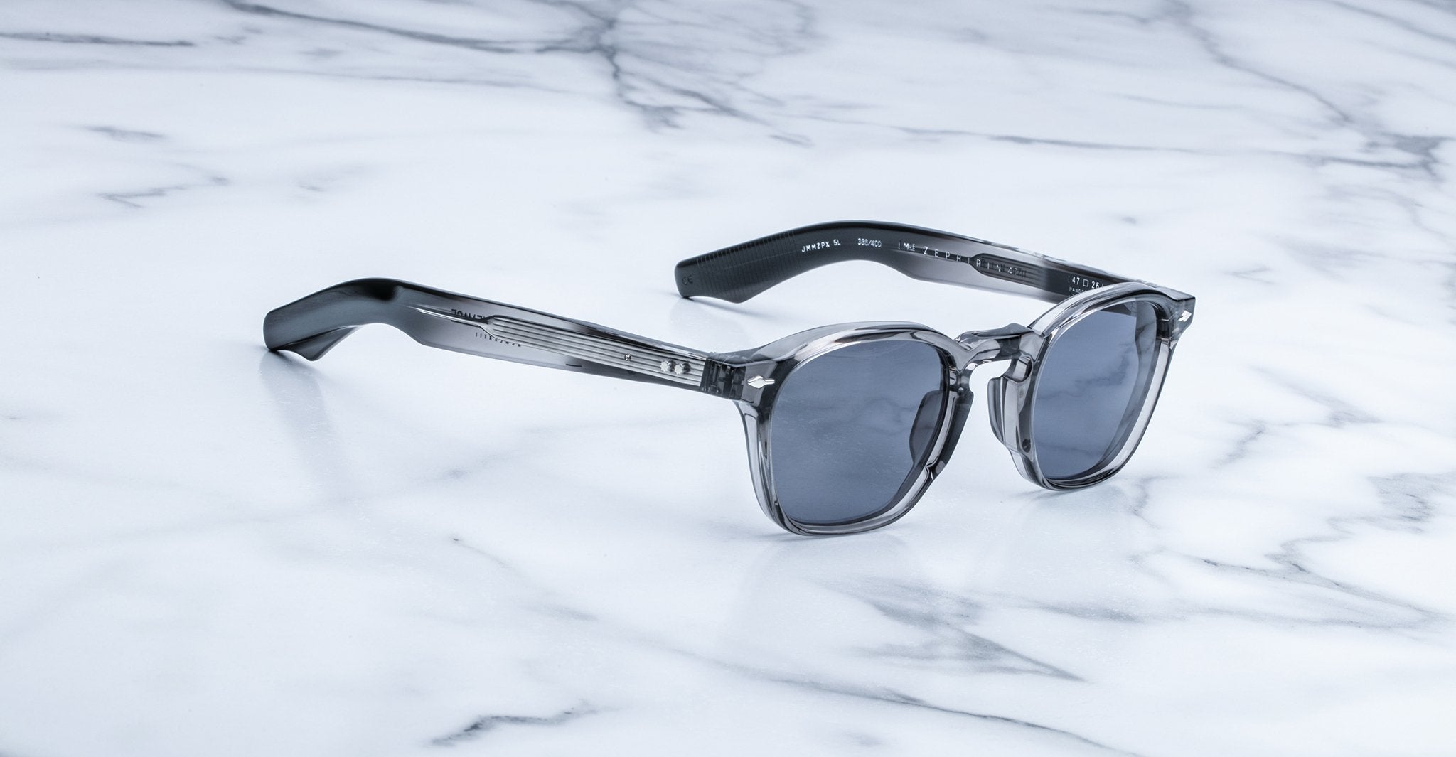 Jacques Marie Mage Zephirin 47 sunglasses, gray and black frames with dark lenses, shown from above.