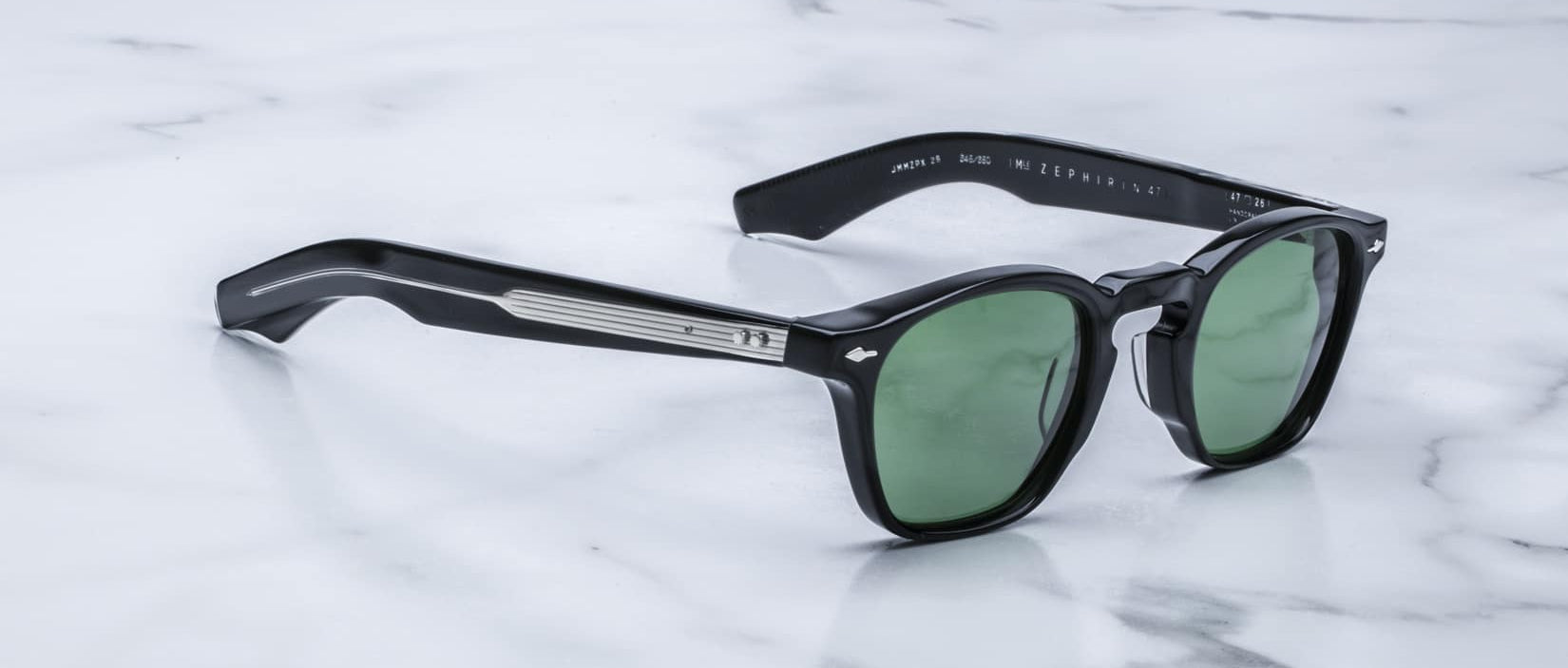 Jacques Marie Mage Zephirin 47 black sunglasses with green lenses and silver accents, front angled view.