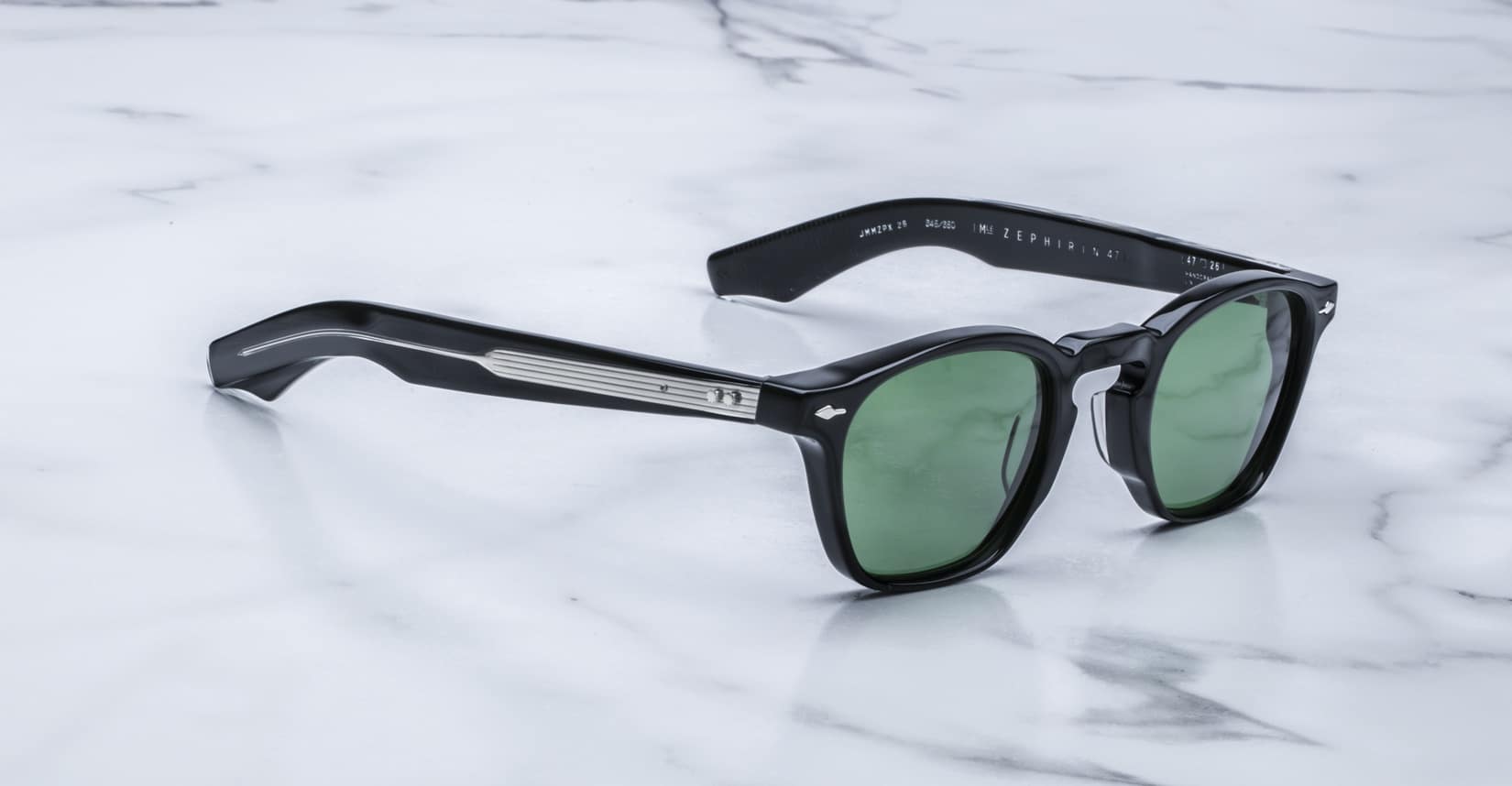 Jacques Marie Mage Zephirin 47 black sunglasses with green lenses and silver accents, front angled view.
