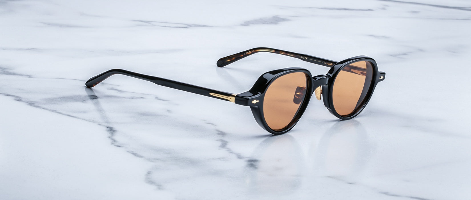 Jacques Marie Mage The Clark round sunglasses with black frames and brown lenses, shown from the front.