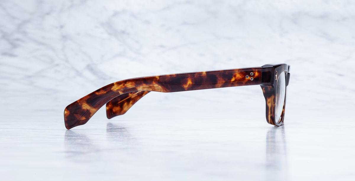 Side view of Jacques Marie Mage Molino brown tortoiseshell eyeglass frames, eyewear displayed at an angle.