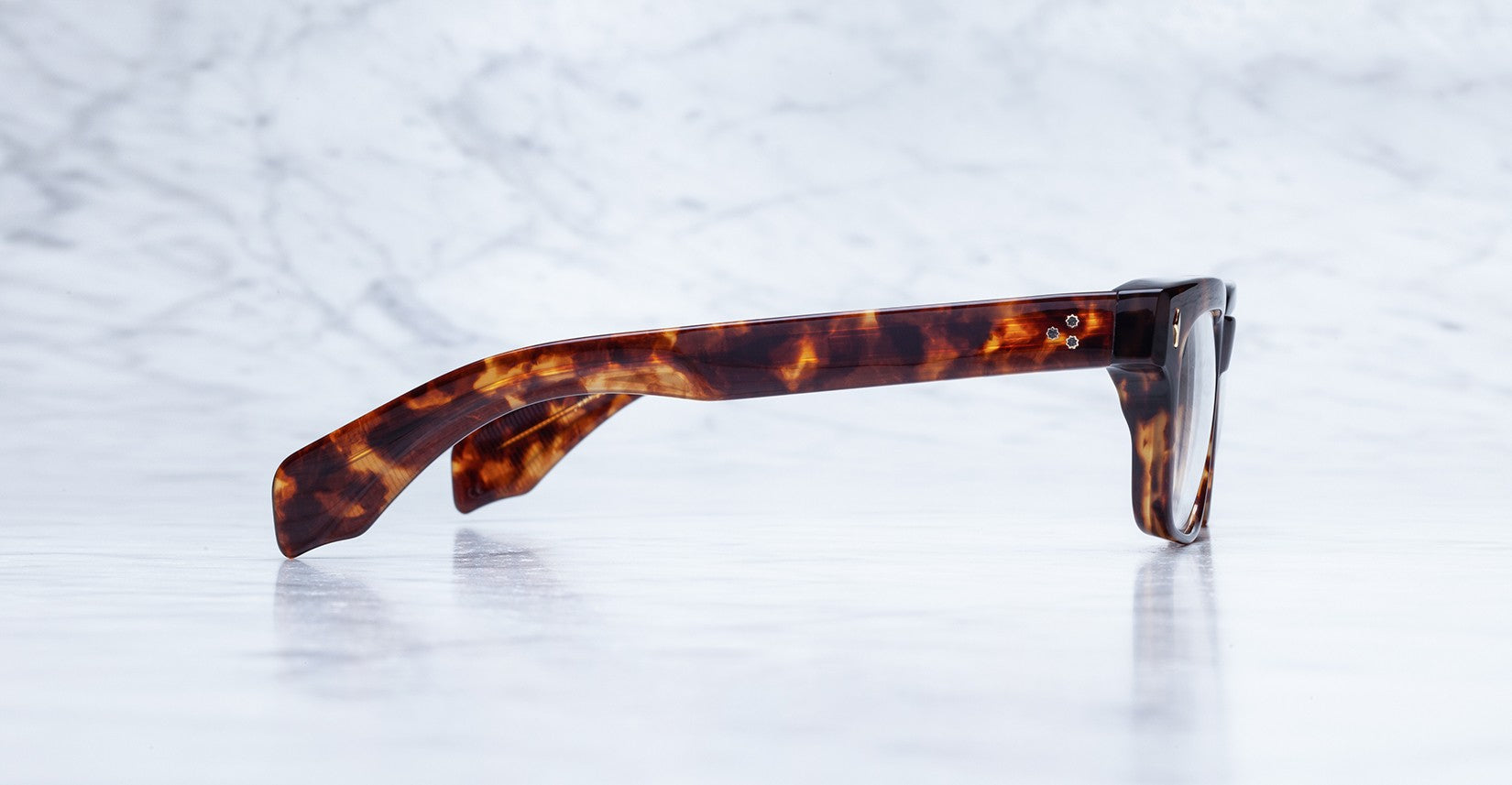 Side view of Jacques Marie Mage Molino brown tortoiseshell eyeglass frames, eyewear displayed at an angle.