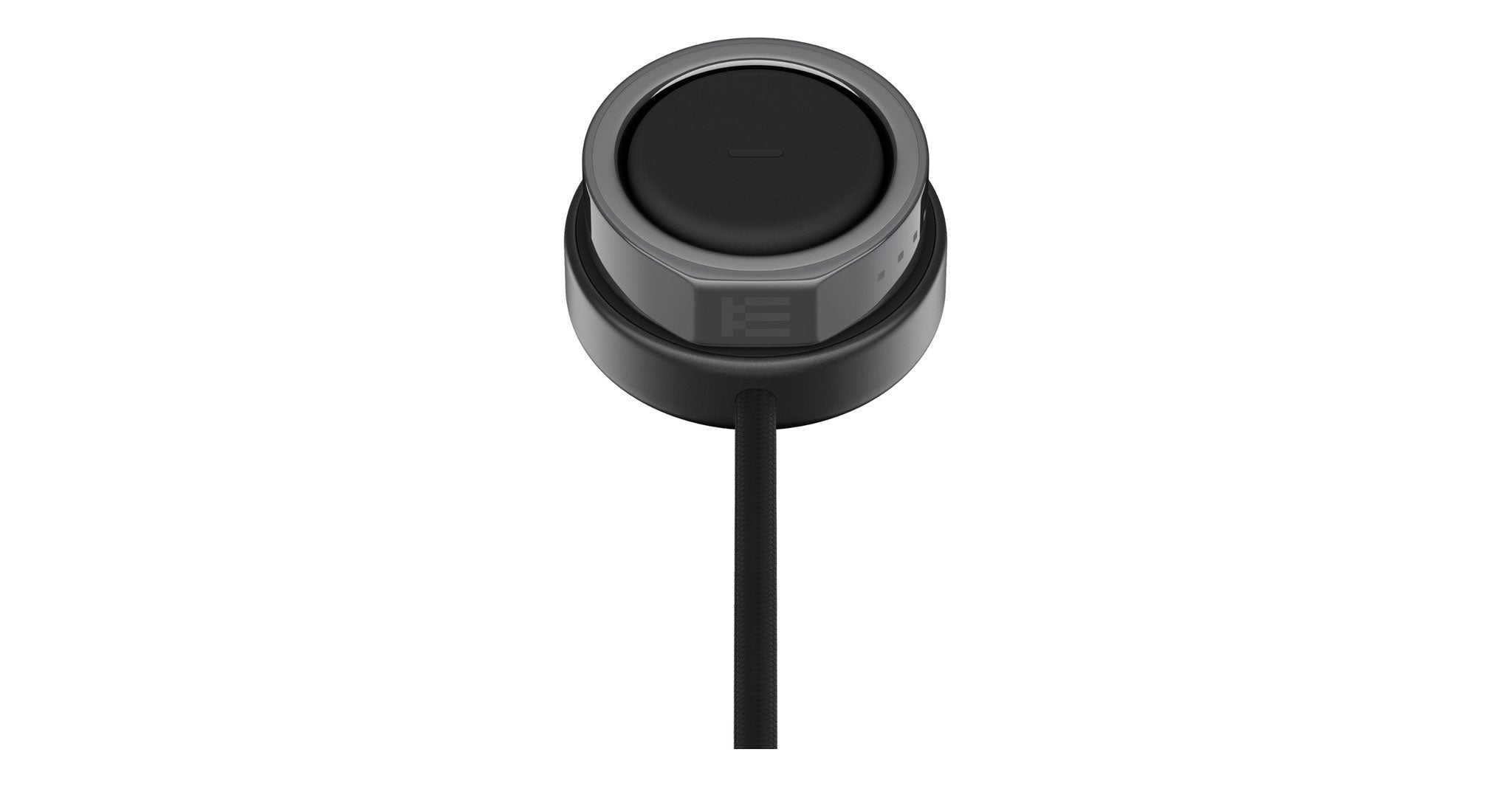 Even Realities R1 Ring wireless charging pad in black with attached cable, top view, by Even Realities.
