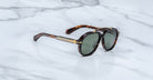 Jacques Marie Mage 1991 sunglasses, tortoiseshell frame, green polarized lenses, gold accents, front angle.