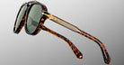 Jacques Marie Mage 1991 tortoiseshell sunglasses with green lenses and gold arm accents, front view.