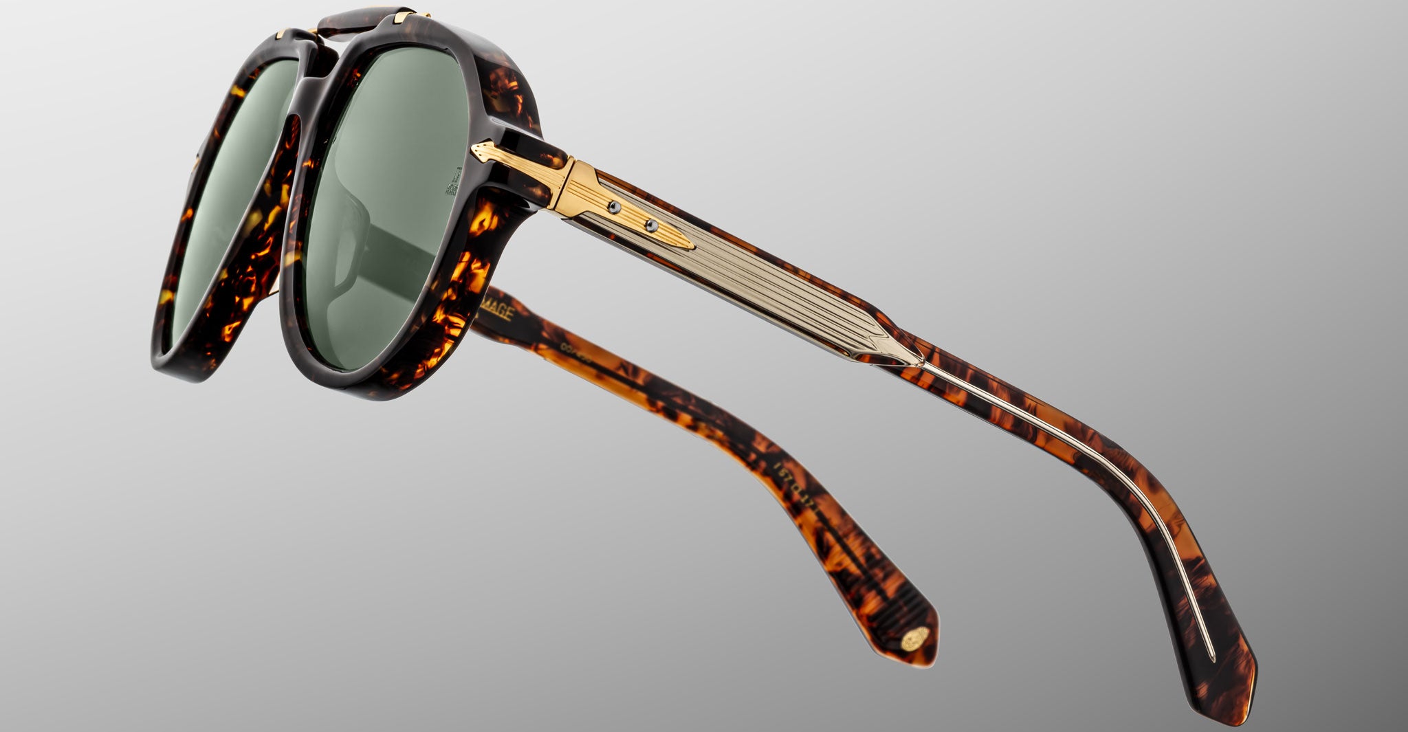 Jacques Marie Mage 1991 tortoiseshell sunglasses with green lenses and gold arm accents, front view.