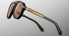 Side view of Jacques Marie Mage 1991 sunglasses in black and gold with brown lenses, designer eyewear model shown.