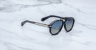 Jacques Marie Mage 1991 polarized sunglasses, black and silver frame with dark lenses, shown from above.