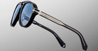 Jacques Marie Mage 1991 sunglasses, black frames, blue lenses, silver accents; product shown from a front-facing angle.