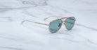 Jacques Marie Mage 755M silver aviator sunglasses with blue lenses, angled view.