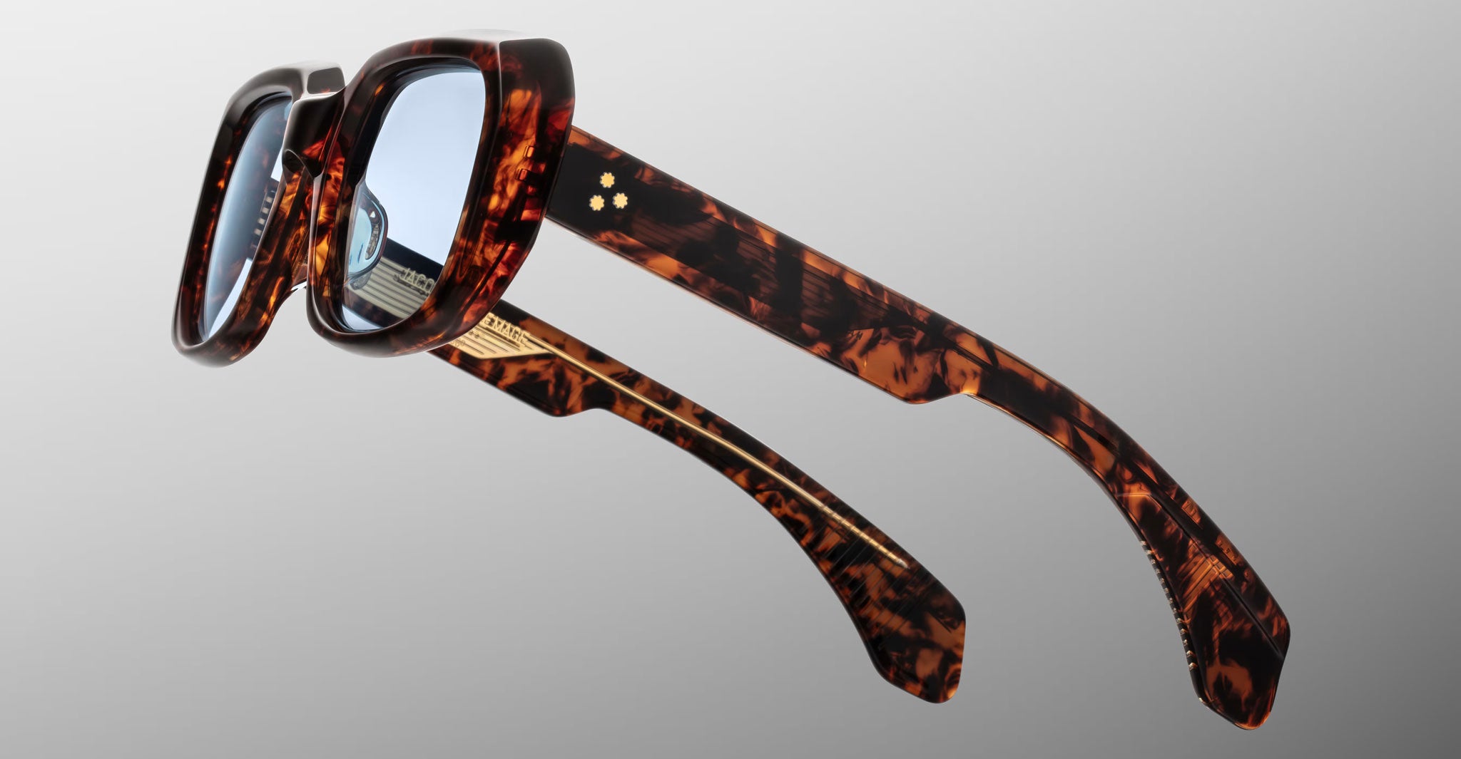 Jacques Marie Mage Aldo thick brown tortoiseshell sunglasses with blue lenses shown from the front.