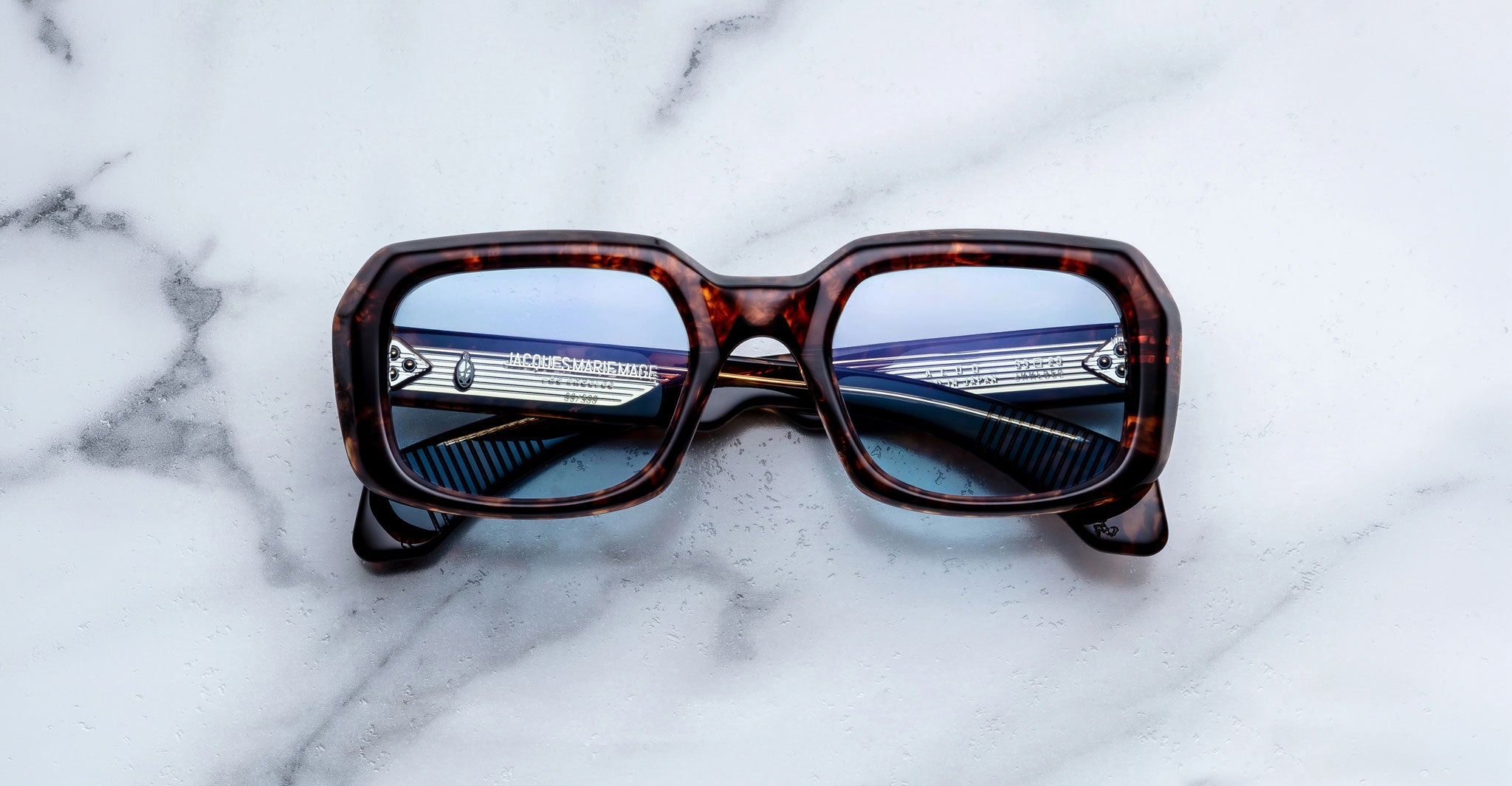 Jacques Marie Mage Aldo sunglasses, tortoiseshell square frame with blue lenses, shown from the front.