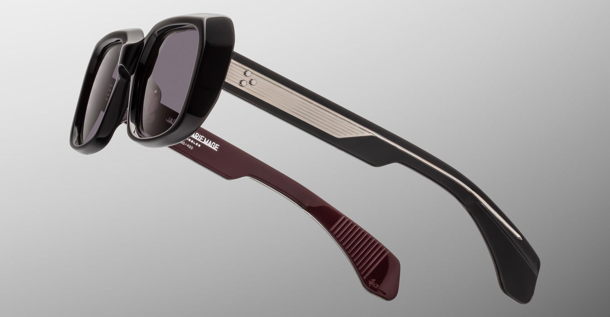 Jacques Marie Mage Aldo sunglasses with thick black frames and gradient burgundy temples, shown from the front.