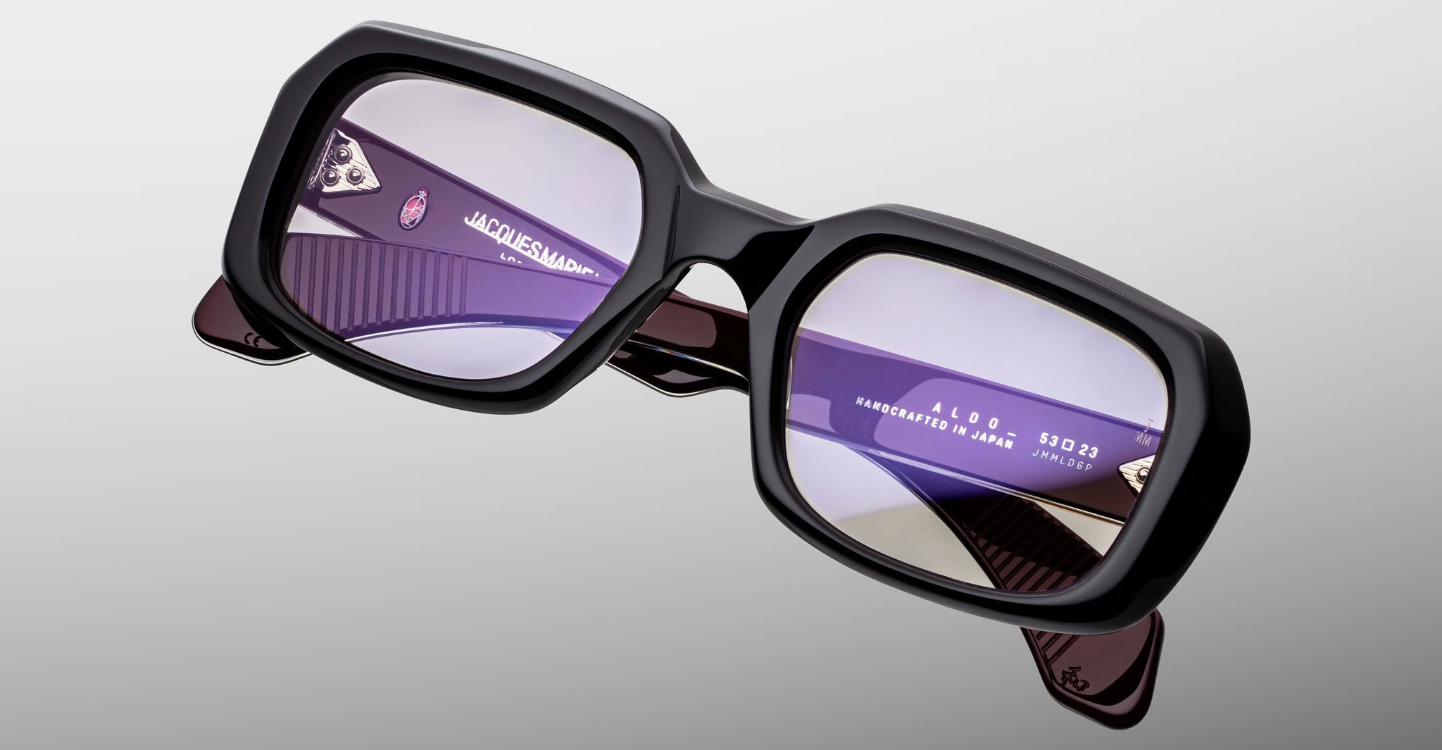 Jacques Marie Mage Aldo sunglasses, black rectangular frames, purple lenses, signature branded temples, front angle view.