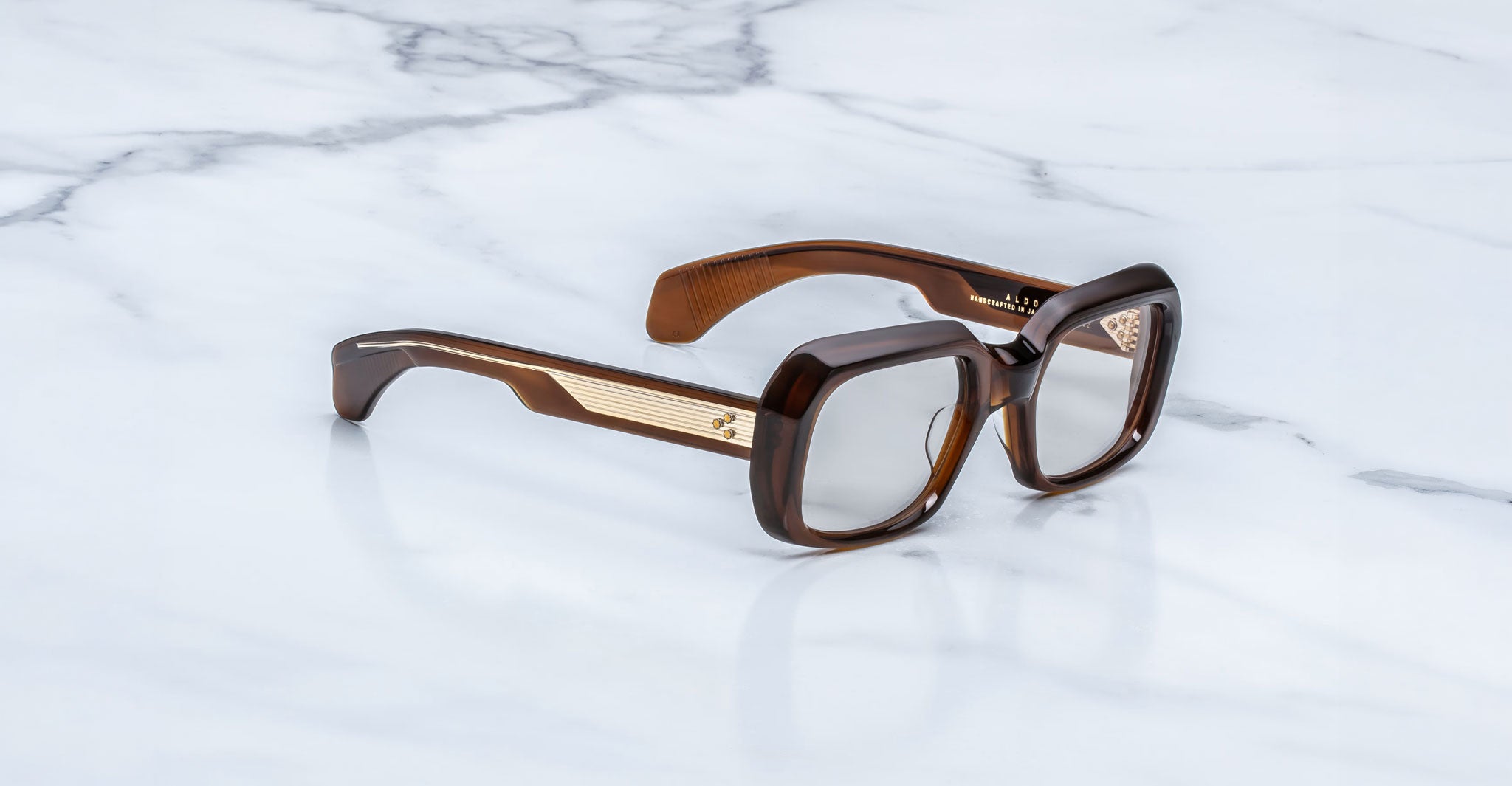 Jacques Marie Mage Aldo brown oversized square eyeglasses with gold temples, top view.