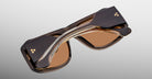 Jacques Marie Mage Alfie sunglasses, folded, thick brown frame with brown-tinted lenses, shown from above.