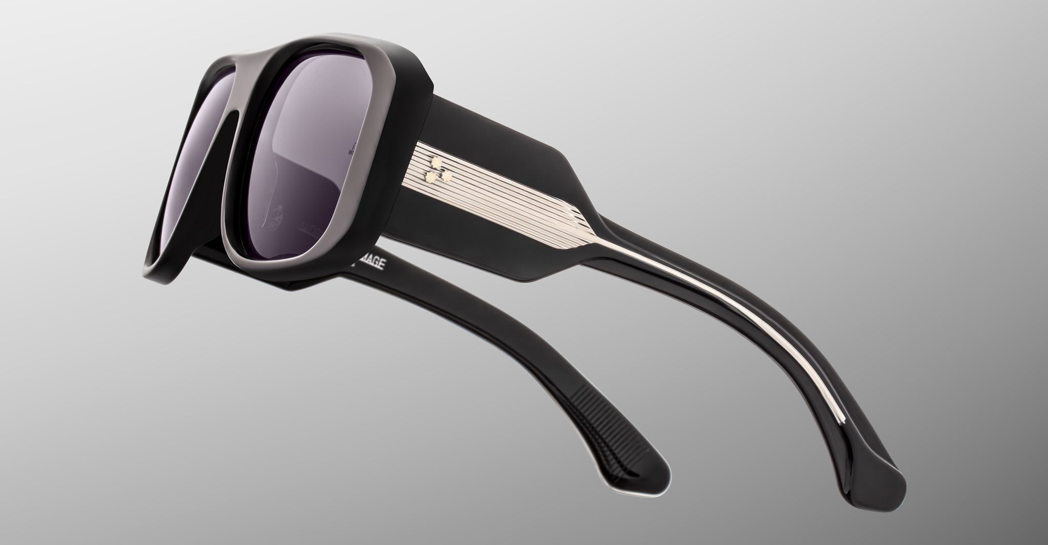 Jacques Marie Mage Alfie black rectangular sunglasses with thick frames, dark lenses, and metallic accents on the temples, front view.