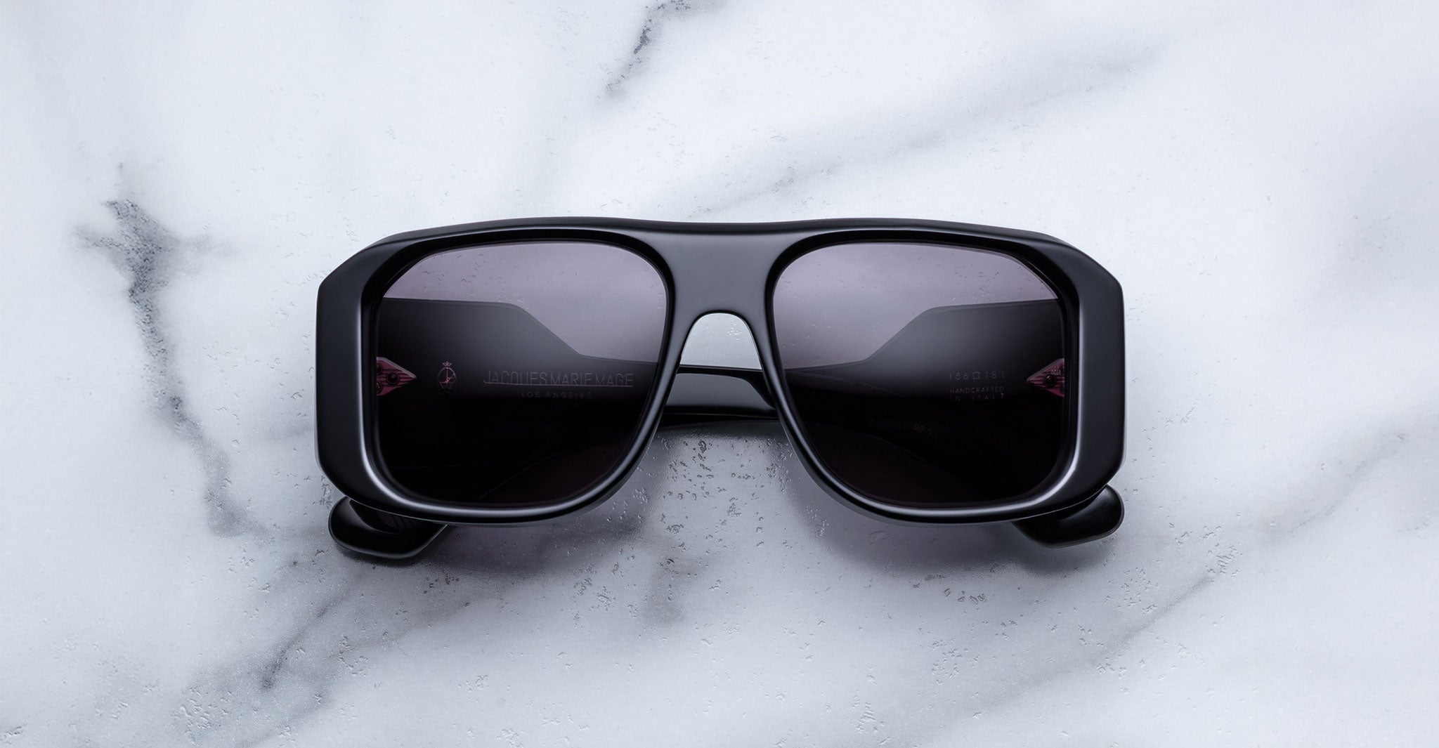 Jacques Marie Mage Alfie black rectangular sunglasses with dark lenses, top view.