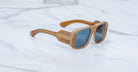 Jacques Marie Mage Alfie sunglasses with tan translucent frames and blue lenses, shown from above.