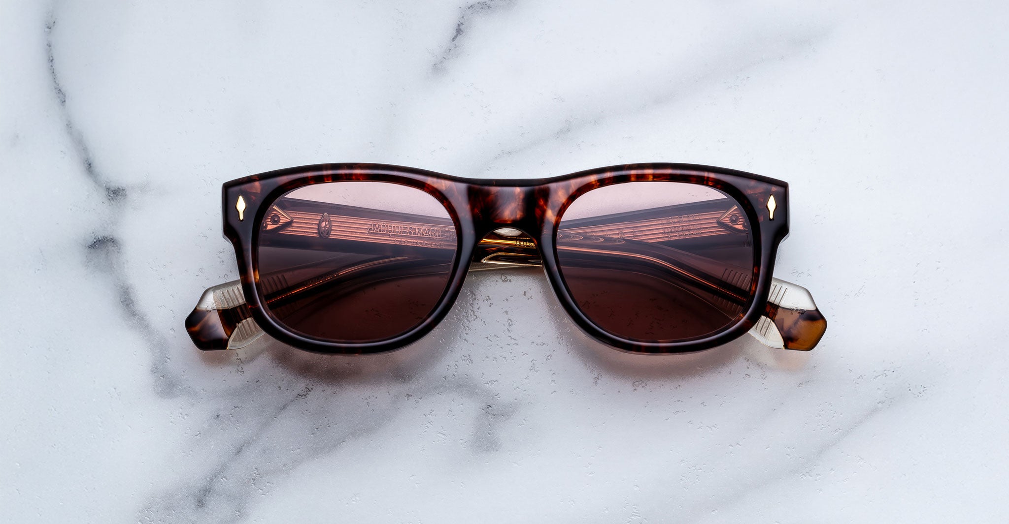 Jacques Marie Mage Amilcar sunglasses with tinted lenses, top view.