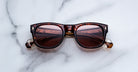 Jacques Marie Mage Amilcar sunglasses with tinted lenses, top view.